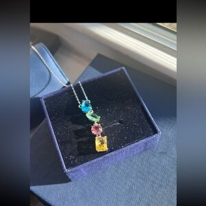 Rhodium plated silver necklace with swarovski elements on pastel color pendant